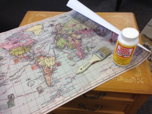 Preparing to 'ModPodge' the map to the table surface.